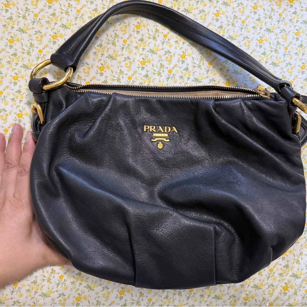 Prada Black Leather Hobo Bag with Gold Accents